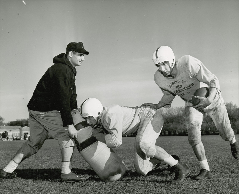 Coach Vince DiFrancesca and player Max Burkett (holding the ball) during practice.