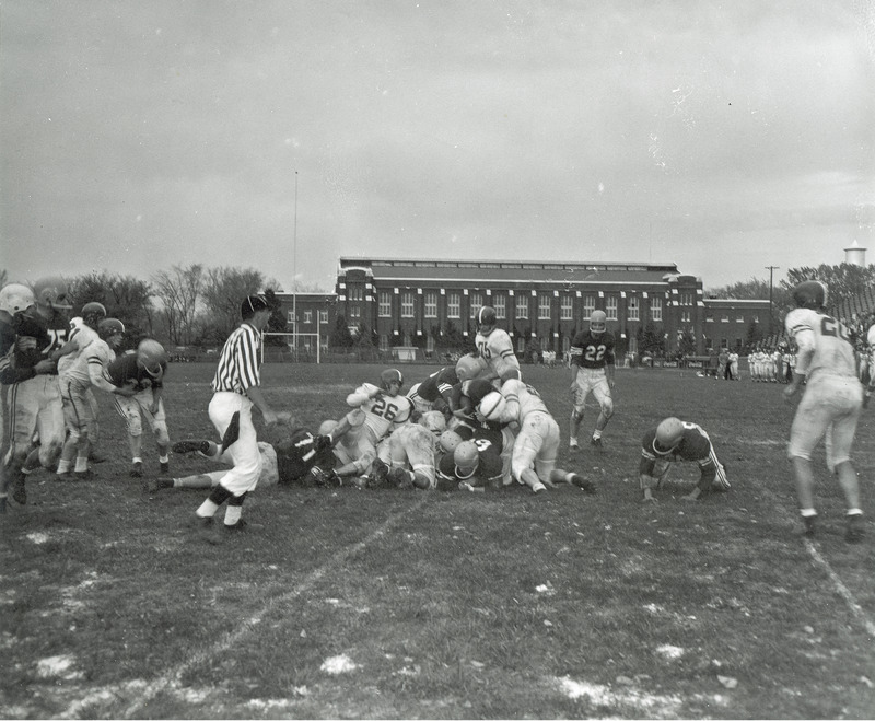 A freshman football game with Nebraska in progress. State Gymnasium can be seen in the background.