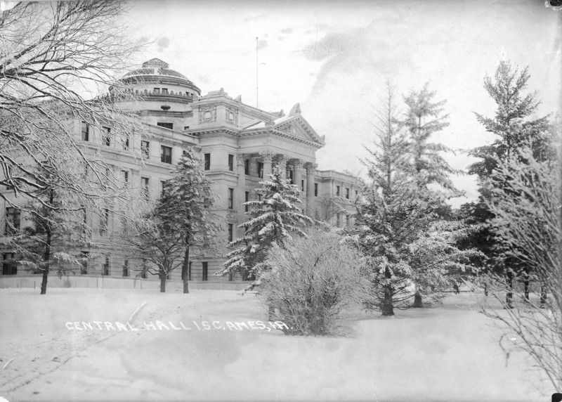 This winter scene depicts the front of Beardshear Hall. Shrubs and trees are covered in frost and snow. Written on the image is "Central Hall I.S.C. Ames, IA.".