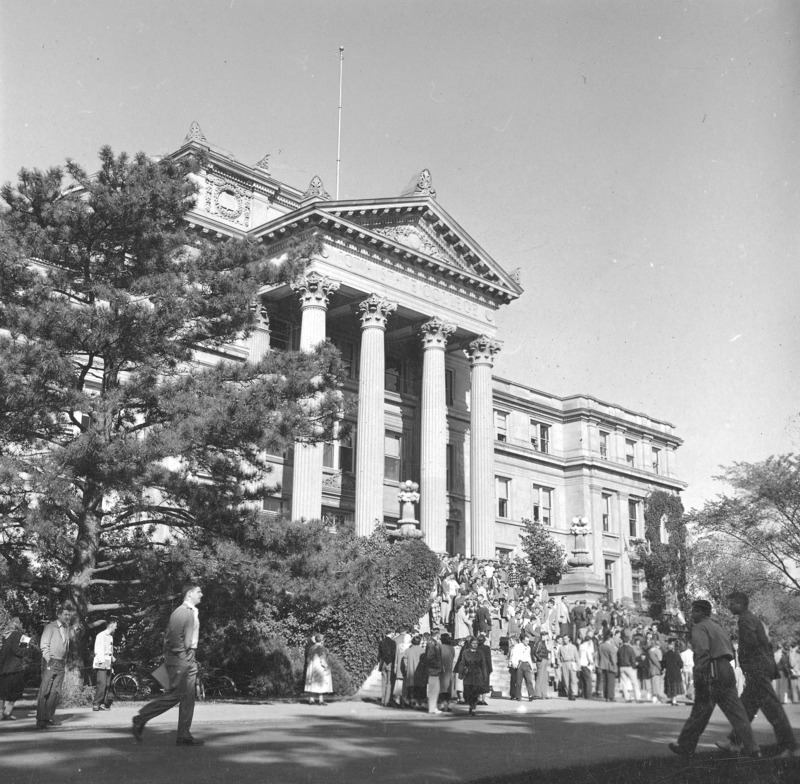 Beardshear Hall from an angle.A large number of people are on the steps and surrounding sidewalk.