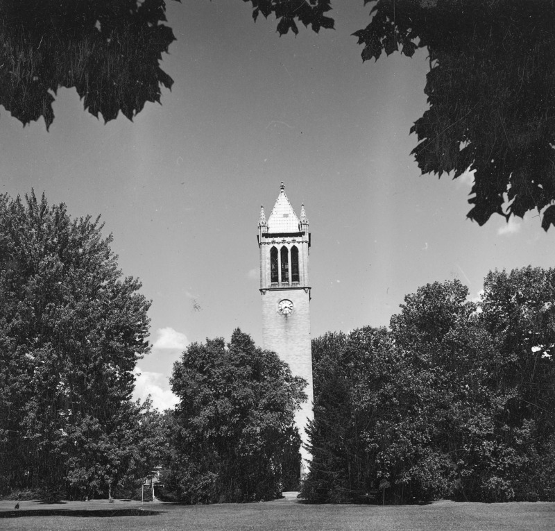 The Campanile surrounded by trees in its central campus setting. Clock shows 3:40. Overhanging fully leafed trees provide a frame for the Campanile as central focus of the photograph. The photograph is one of a set of four, each almost identical to the other but varying slightly in location. the other photographs in the set are: 4-8-I. Campanile.230-7-2-1; 4-8-1.Campanile.230-7-2-3; and 4-8-I.Campanile.230-7-2-4.