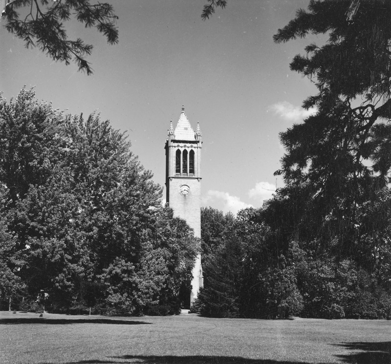 The Campanile surrounded by trees in its central campus setting. Clock shows 3:39. Overhanging fully leafed trees provide a frame for The Campanile as central focus of the photograph. The photograph is one of a set of four, each almost identical to the other but varying slightly in location. The other photographs in the set are: 4-8-I. Campanile.230-7-2-1; 4-8-1.Campanile.230-7-2-2; and 4-8-I.Campanile.230-7-2-4.