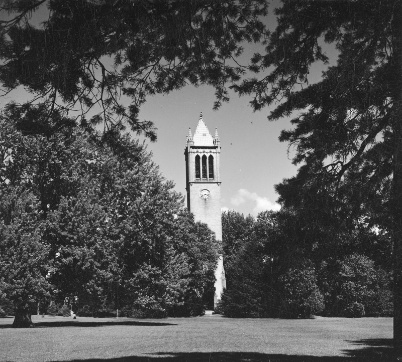 The Campanile surrounded by trees in its central campus setting. Clock shows 3:40. Overhanging fully leafed trees provide a frame for the Campanile as central focus of the photograph. The photograph is one of a set of four, each almost identical to the other but varying slightly in location. The other photographs in the set are: 4-8-I. Campanile.230-7-2-1; 4-8-1.Campanile.230-7-2-2; and 4-8-I.Campanile.230-7-2-3.