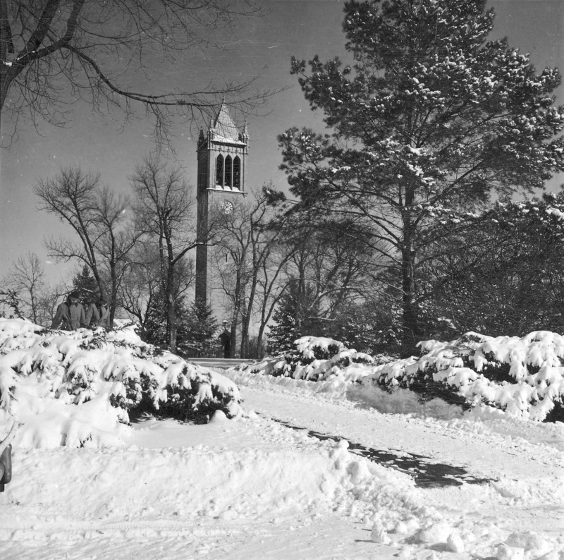 Central campus in winter. An empty snow covered sidewalk is in the foreground with the Campanile in the distance. Clock shows 10:38. One of a set of five winter photographs, the others of which are: 4-8-I.Campanile.230-7-6-2 [not digitized]; 4-8-I.Campanile.230-7-6-3; 4-8-I.Campanile.230-7-6-4; and 4-8-I.Campanile.230-7-6-5.