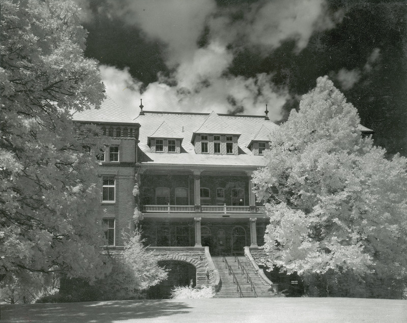 The front of Catt Hall and focuses on the stairs and entryway. Trees partially obscure both sides of the front. This image is part of a set of images that includes: w 4-8-I.Catt Hall.234-4-2-2.