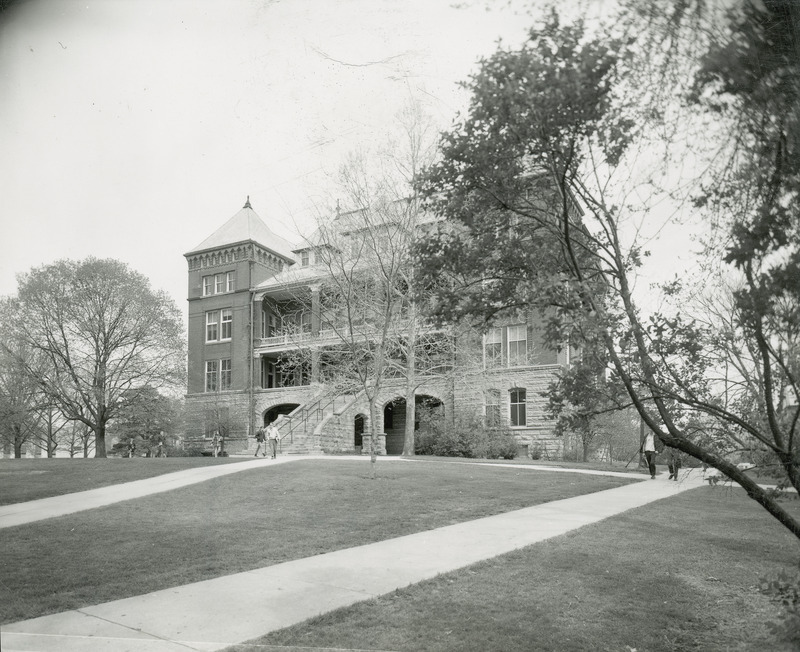 Catt Hall in the distance with the surrounding trees, lawn and sidewalks in the foreground. This image is part of a set of images that includes: w 4-8-I.CattHall.234-4-3-1.