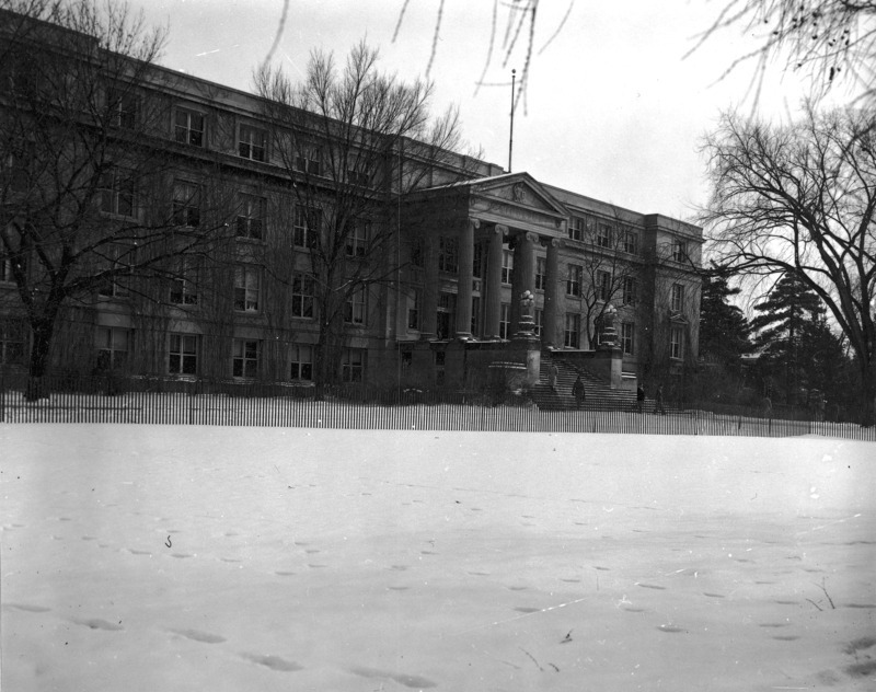 Curtiss Hall is viewed from the northwest behind the snow fence protecting it from the snow on central campus.