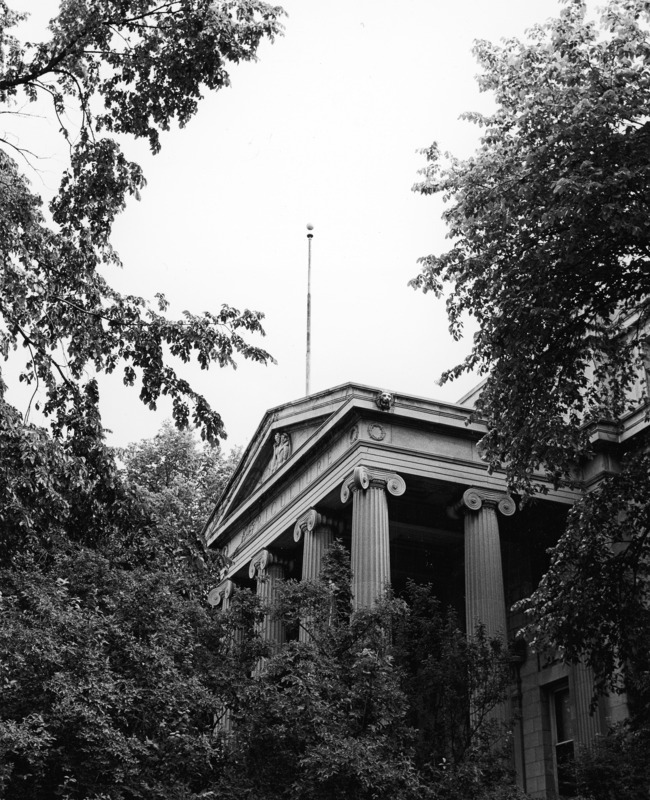 The Curtiss Hall entrance columns are surrounded by trees, viewed from the southwest.