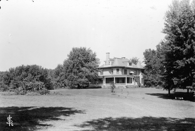 Trees and the front lawn surround the Knoll in this view from of the southeast corner of the building.