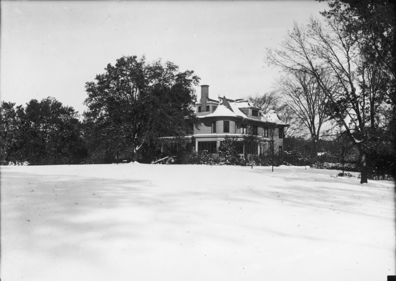 The south east corner of the Knoll can be seen across a large expanse of snow covered lawn.