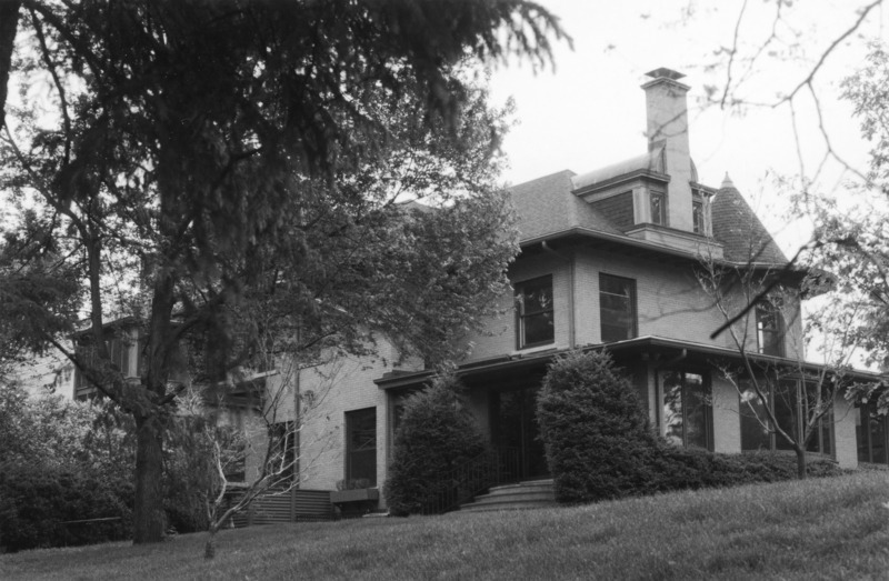 A porch with large ceiling to floor glass windows is the central focus of this 2001 view of the southwest corner of the Knoll.