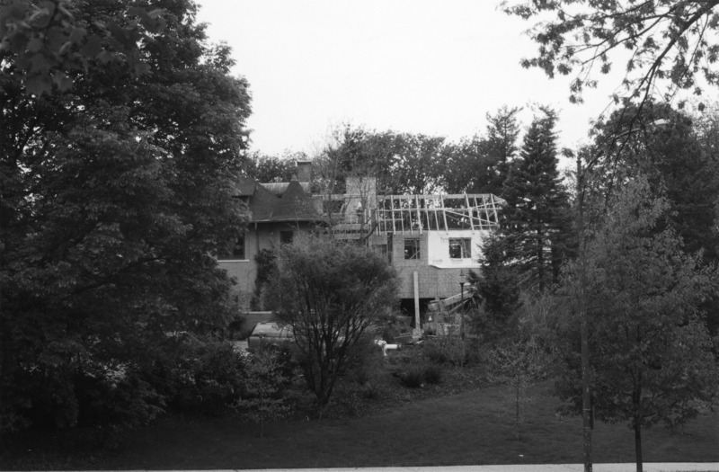 This view of the Knoll clearly shows the extent of the renovations that took place in 2001. There various construction vehicles parked in front of the building. The entire scene is framed by the surrounding trees.