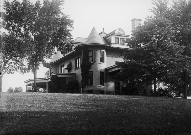 This ground view of the Knoll features the northeast corner. Climbing ivy is on the northeast tower and the porte cochere is partially hidden by a tree.