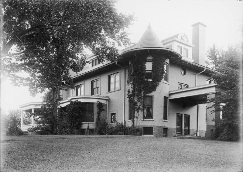 This northeast view of the Knoll features the porte cochere, ivy covered tower and a bit of the front entryway. A small part of the wrap around porch is also visible.