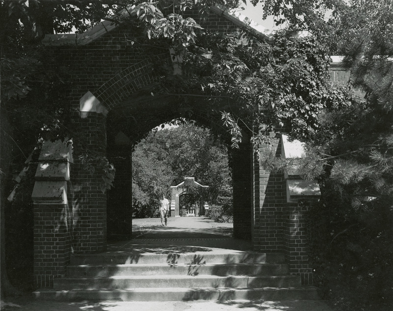 Man walking through the courtyard of Lagomarcino Hall (then called the Quadrangle) in 1938.