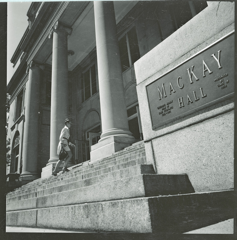 Woman walking up the steps of MacKay Hall in 1973.