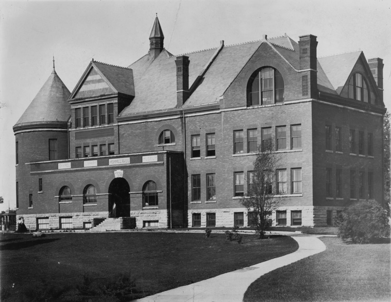 A sidewalk leads up to the front steps of Morrill Hall.