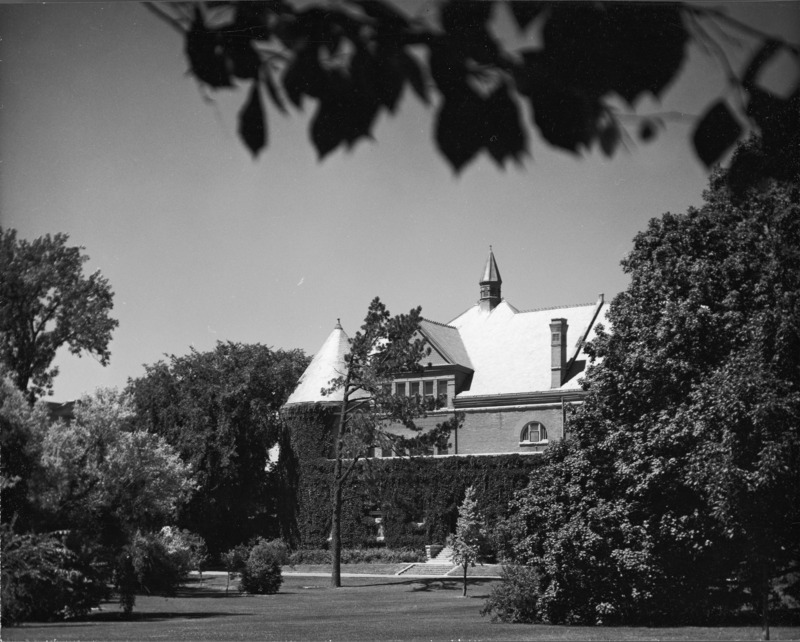 Ivy has grown along the lower portion of Morrill Hall and the tower and partially covers the windows.