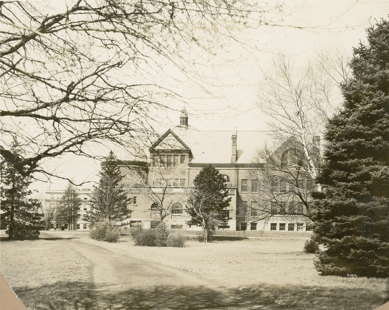 A tree blocks the view of the main entrance to Morrill Hall. Marston Hall is in the background.