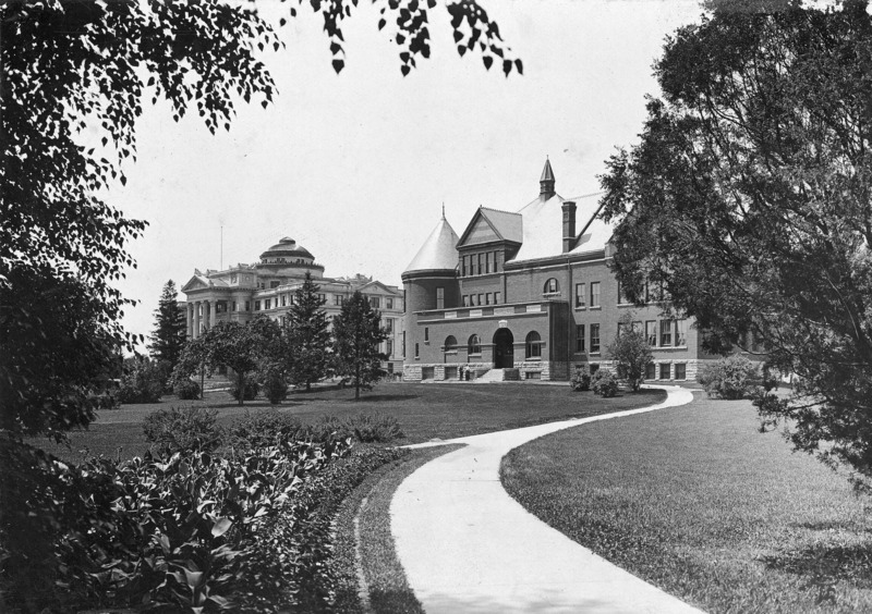 A sidewalk leads up to the entrance of Morrill Hall. Central Building (Beardshear Hall) is to the left.