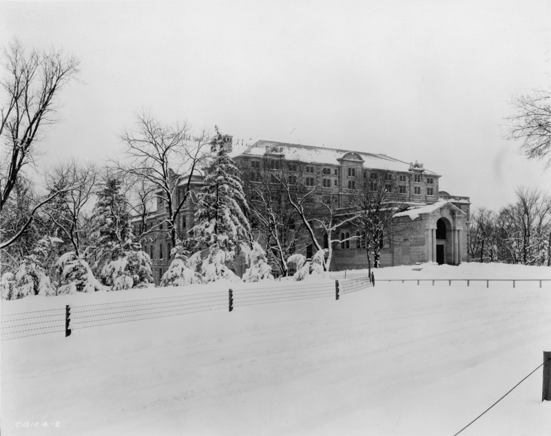 Snow blankets the north facade of the Memorial Union, the surrounding lawn and trees in this winter view.