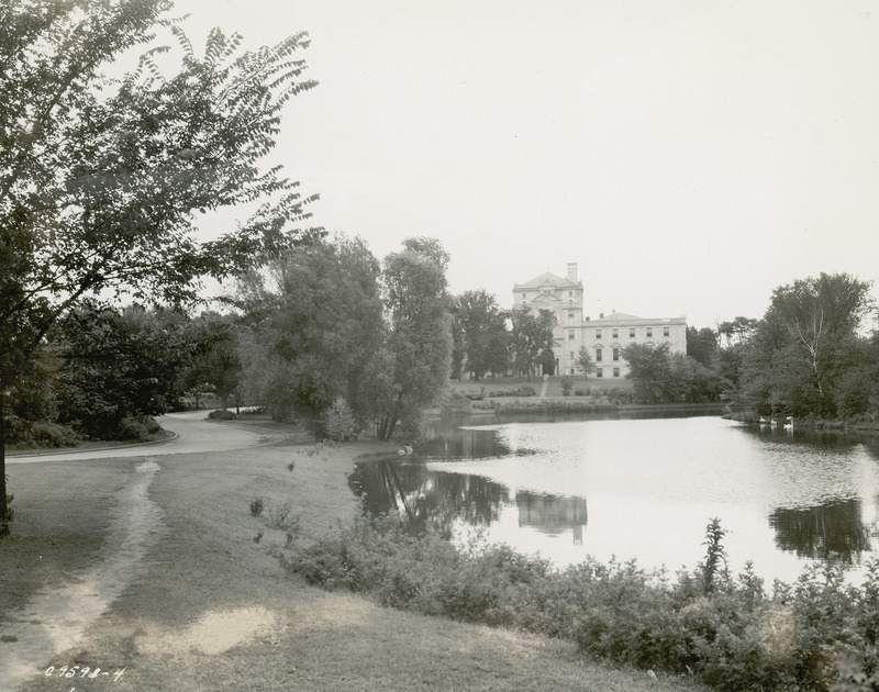 Lake LaVerne, the surrounding path and vegetation occupy the foreground of this image. The west facade of the Memorial Union appears on the distant shore.