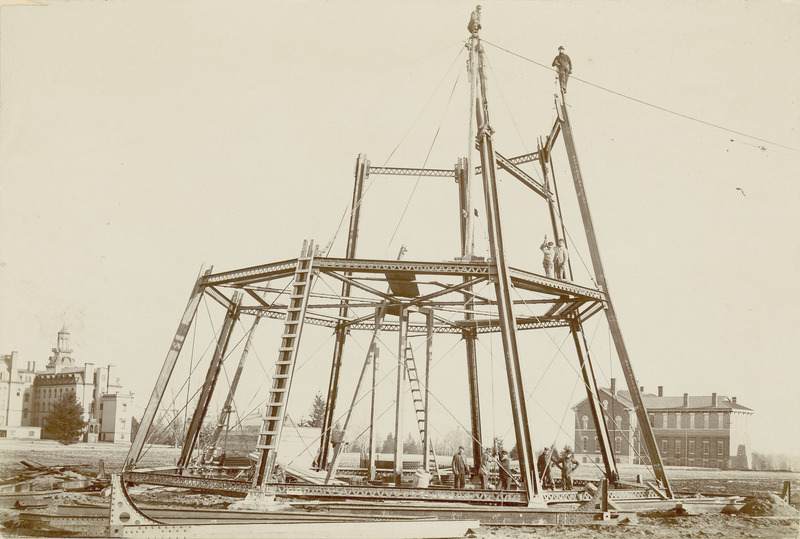 The Water Tower construction site on March 22, 1897, about 5:00 PM. Old Main and the Chemical and Physical Laboratory are visible in the distance.