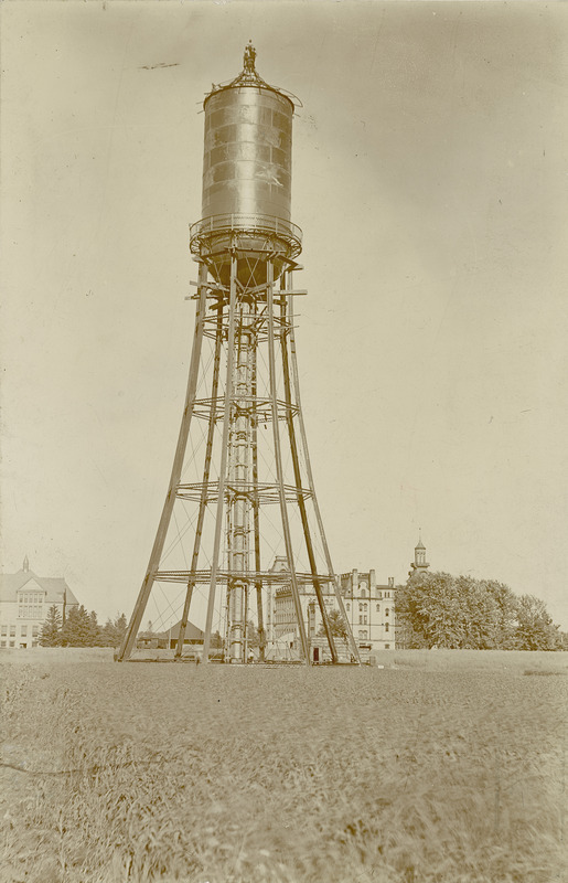 The Marston Water Tower stands in the foreground with Old Main and Morrill Hall in the distance.