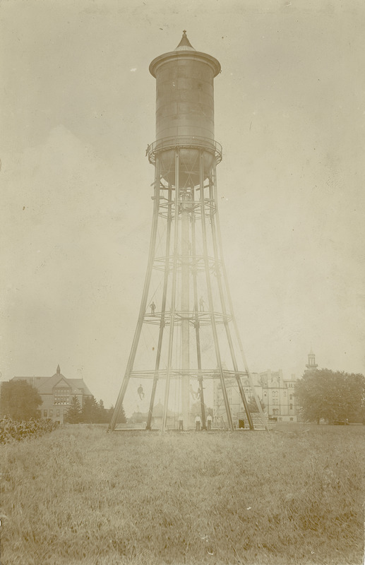 The Marston Water Tower stands in the foreground with Old Main and Morrill Hall in the distance.