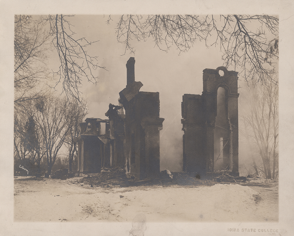 Photograph of the burned remains of South Hall after a fire on January 5, 1912. The image shows a partially destroyed brick structure with standing walls and arches, surrounded by leafless trees and snow. The view is looking southeast. Annotation: "Professor's Residence. President's House. Burned Jan 5, 1912. Music Hall in 1912."