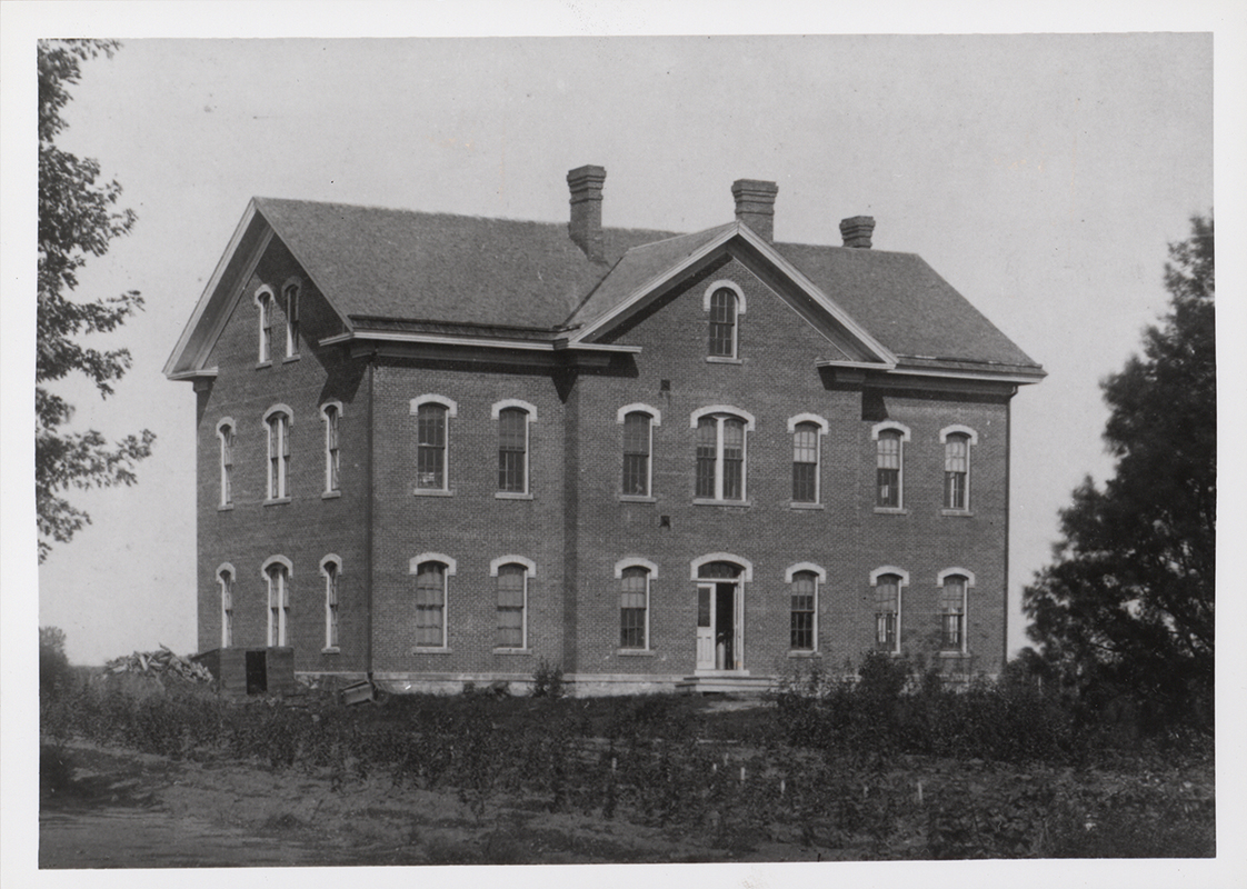 Photograph of North Hall on the Iowa State campus, showing the south and west elevations. The image depicts a three-story brick building with arched windows and a central entrance. Annotation: "Fig. 11 North Hall."