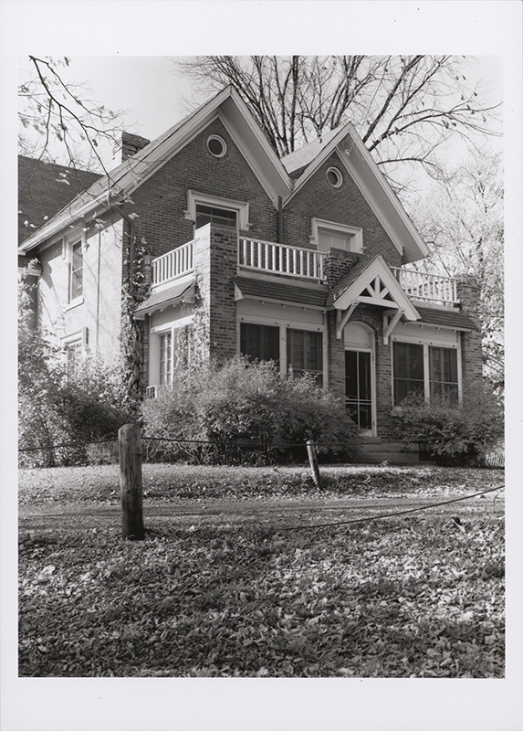 Photograph of Old Music Hall, showing the south and west elevations of a two-story brick building with balconies. The building is surrounded by trees. Annotation: "Old Music Hall. n.d. no neg b/w."