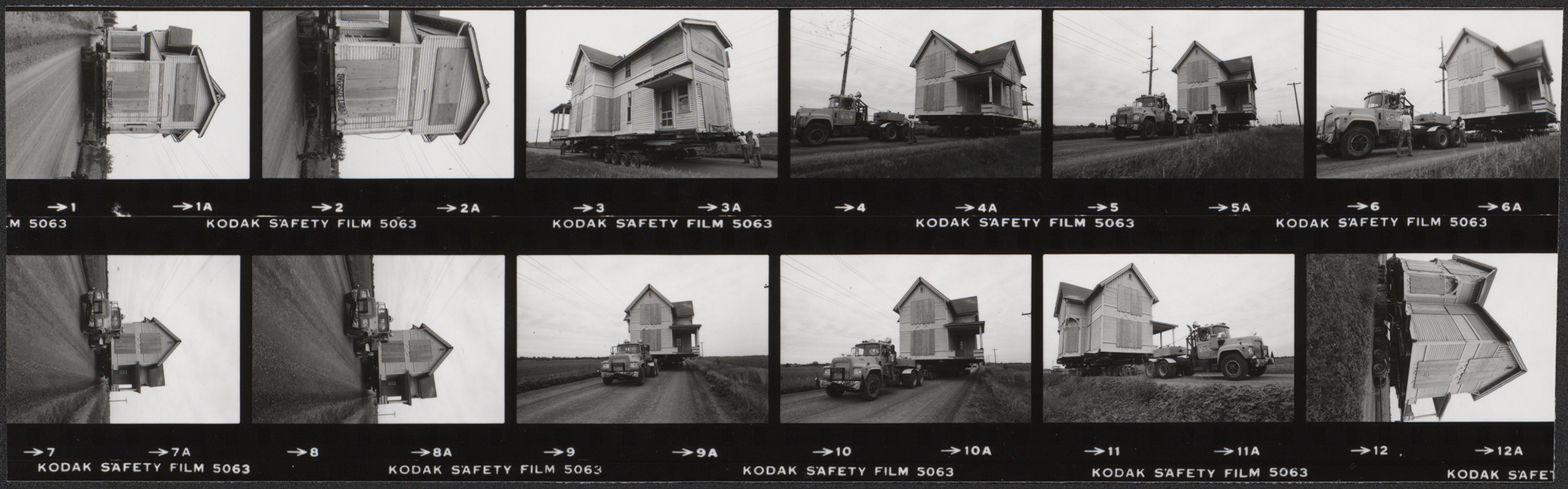 Contact sheet consisting of a strip of photographs documenting the relocation of Pope Cottage off the Iowa State campus. The images show a small wooden house being transported along a rural road on a trailer pulled by a truck, with sequential views capturing different stages of the move. Annotation: "Moving Pope Cottage off campus. 1981 (June 11). Neg #'s 030128-030129 (strip).''