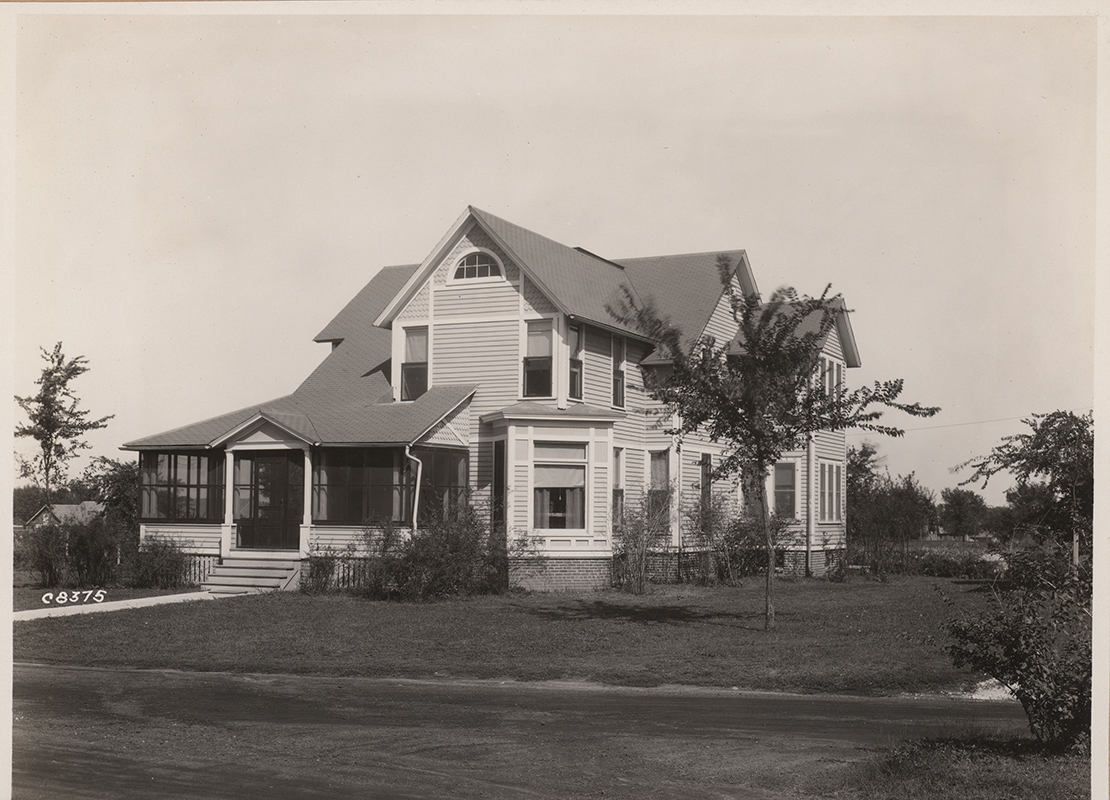 Photograph of Coburn House taken from across a road. The front porch has been screened in.
