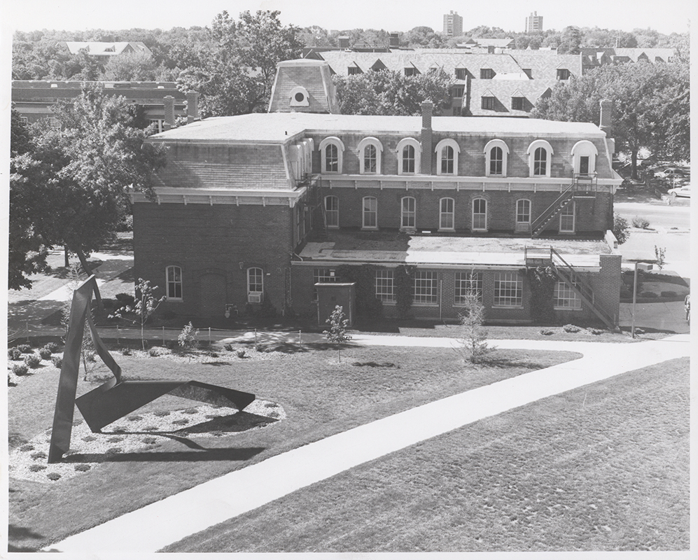 Photograph of the north side of the Laboratory of Mechanics looking down from Black Engineering with the Student Services Building and Friley Hall visible behind (at the top). Annotation: ''Lab of Mechanics Bldg 6/89 from top of Black Engineering.''