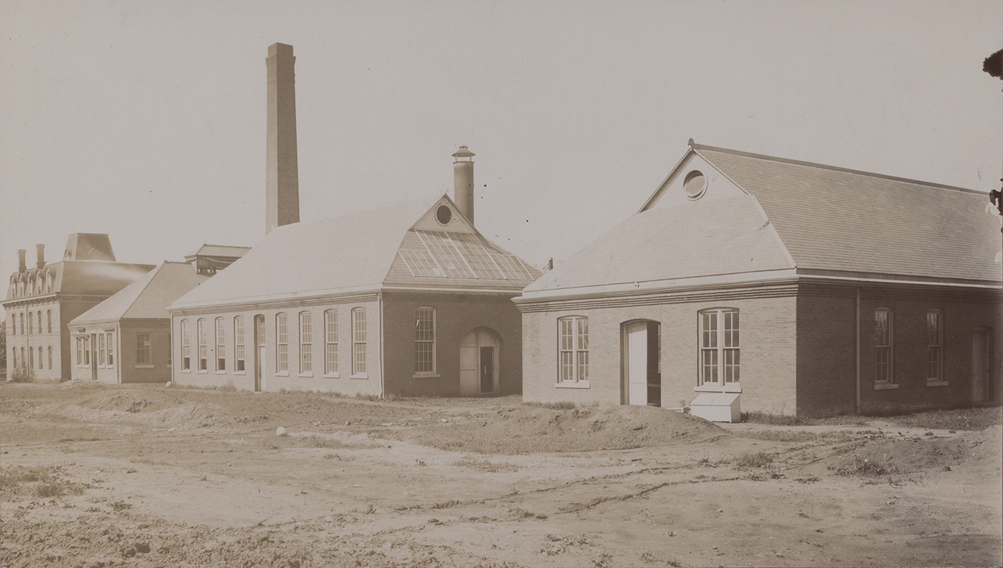 Photograph of the engineering laboratories. From left to right (south to north) these buildings are the Laboratory of Mechanics, the Power Station, Building A, and the Aerospace Laboratory. Annotation: ''L to r; Old Eng Hall now T & A M; Power Station; Forge Shop & Foundry; Pattern Shop.''