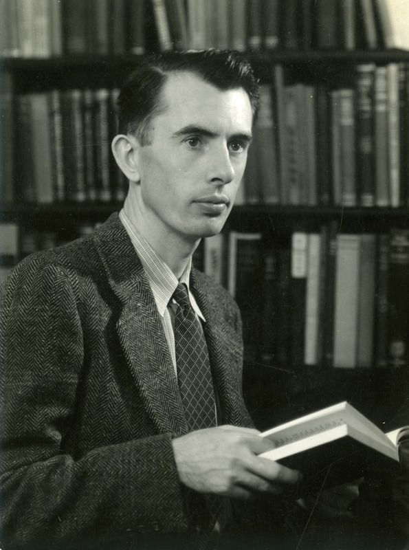 Robert W. Orr, Professor and Director of Libraries, is holding a book in this portrait taken in 1940.