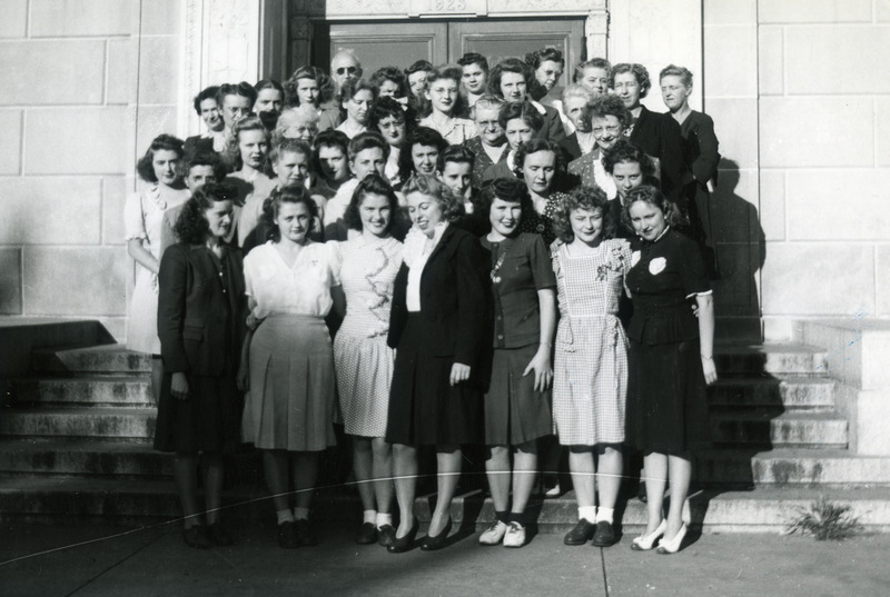 The library staff is shown in this group portrait taken in September 1944. They are: Front row (left to right) Dorothy Delamore, Darlene Albinger, Virginia Gallagher, Margaret Mae Gross, Mary Ellen Gallagher, Evelyn Clouser, Dorothy L. Mott; Row 2 (left to right) Grace M. Oberheim, Gertrude Voelker, Kathryn Renfro, Jean Cook, Agnes Grimsrud, Patricia Carty; Row 3 (left to right) Alice Olson, Kathleen Jorgenson, Marjorie Flynn, Marian Mathews, Helen Hurlbutt, Helen Crawford; Row 4 (left to right) Elizabeth Oakberg, E. Frances Warner, Marian Landgraf, Evelyn Wimersberger, Blanche Johns; Row 5 (left to right) Edna M. Gomberg, Betty P. McAlpin, Evelyn Heuer, Helen Gerber, Ruth Sprecher, Ida Robertson, Victoria Hargrave; Row 6 (left to right) Charles H. Brown, Betty J. Anderson, unknown student worker, Fern Wood, Leona Ayres, Ina Kreaemer, Eva L. Robbins.