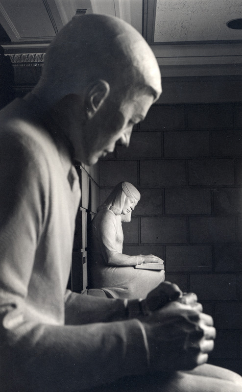 Christian Petersen's Sculpture: Library Boy and Girl appears in close-up view with the boy in the foreground and the girl in the background.