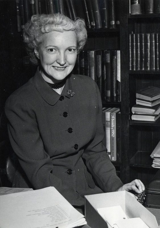 Mrs. Dorothy Kehlenbeck, Curator of the College Historical Collection is seated at a desk using a typewriter.