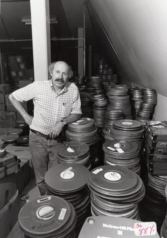 Stan Yates, Archives and Special Collections poses with the American Archives of the Factual Film collection.