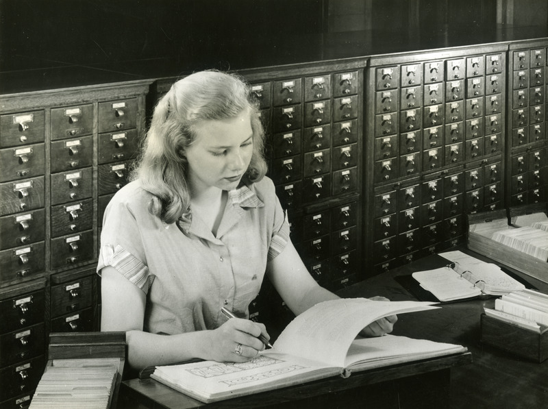 A student checks reference material in the College Library. All new students take a 6 week course in Library, designed to help them know the facilities of the Library and how to make use of them.