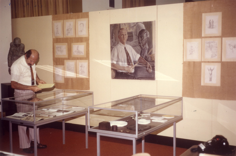 University Archivist Stan Yates examines the contents of a display case from the Christian Petersen exhibit held in 1972.