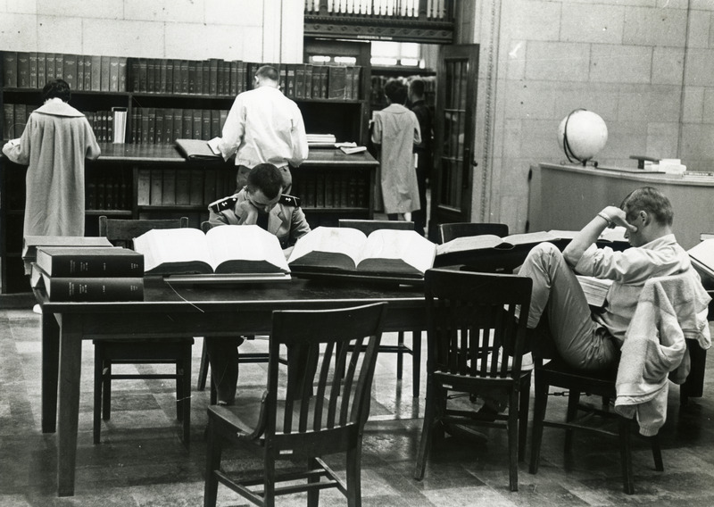 Students use indexes and study at tables in the reference area outside the Periodical Room.