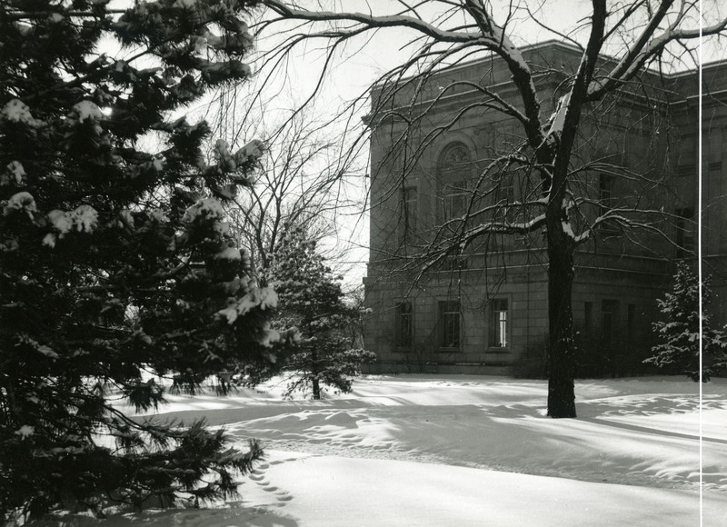 Snow-covered trees surround this north view of the library.