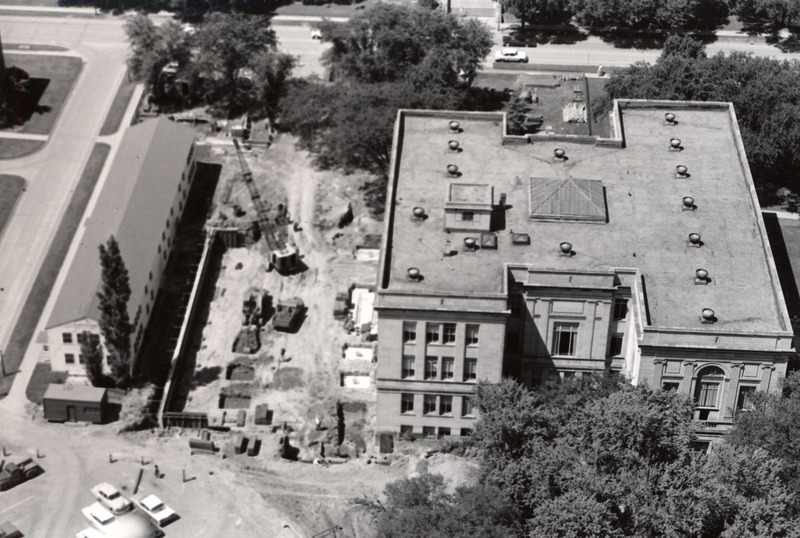 This aerial view shows the excavation site for the 1st addition to the library. A war surplus building, Number "N" appears on the far left. It was taken down in 1968 prior to construction of the 2nd addition.