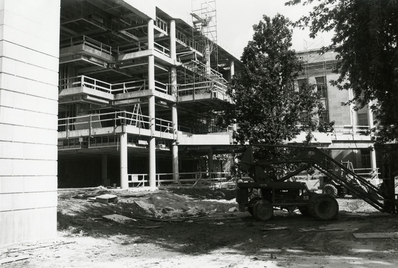 The four floors are visible in this view of the 3rd addition library construction. A small crane and bull dozer are on the right. Scaffolding is in place alongside the building.