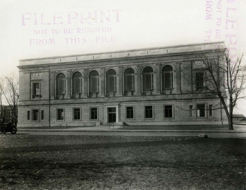 This east view of the newly constructed library shows the original east entrance. A model T is parked to the left of the building.