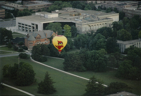 Aerial view of Iowa State University Library (now Parks Library), probably in the 1980's. A hot-air balloon with a Cy decal can be seen in the foreground.