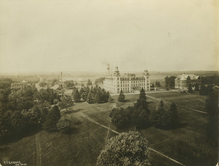 An aerial view of Old Main (later known as Central Building and Beardshear Hall) in the center and Morrill Hall on the right. Other campus buildings are to the left of Old Main.